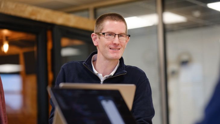 A photo of Chris smiling in the Brightec Studio