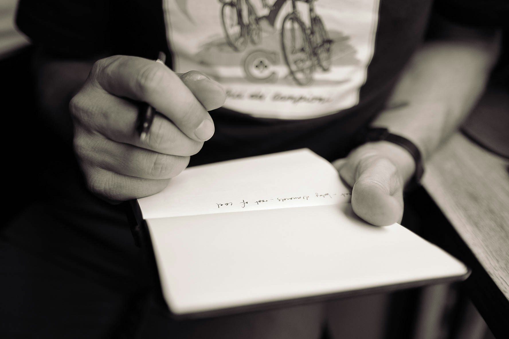 A photo of someone hand writing notes on a notebook (Calum MacAulay on Unsplash)