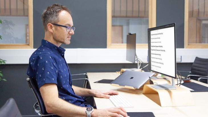 A photo of James working at his desk